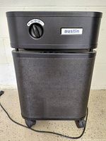 Full view of black Austin HealthMate air purifier on casters