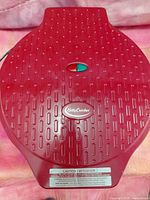 Top view of closed red Betty Crocker pizza maker showing logo and indicator lights