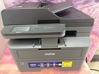 Front and side view of Brother MFC-L2820DW showing overall condition, paper tray, ADF and control panel