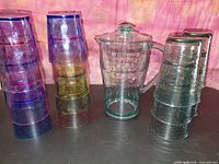 entire set showing pitcher and stacked coloured tumblers