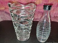 Vase and bottle side by side showing overall form and lid