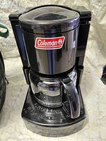 Front view of Coleman 5008-700 camping coffee maker with glass carafe