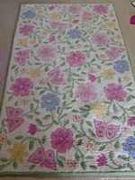 Full view of floral cream area rug