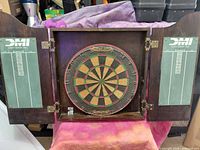 cabinet open showing dartboard and scoreboards