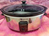 Front view of Farberware stainless slow cooker showing body, handles and control dial