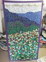 Full view of the quilt showing complete landscape design and purple border