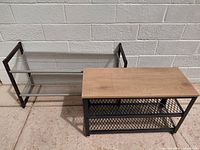 Overall view of assembled metal shoe rack showing wood top and two shelves