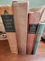 Spines of all four hardcover books showing titles and colours