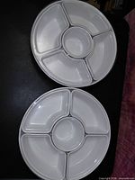 Two round plastic chip-and-dip trays side by side