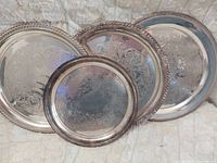 All four trays leaning together displaying size differences and engraving