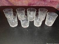 All eight crystal glasses upright showing pattern