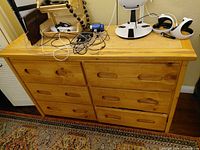 Front view showing six drawers, recessed pulls and overall finish