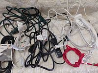 Assortment of ten extension cords in various colours and USB hub visible