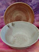 Both bowls, shallow bowl standing behind deep bowl