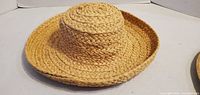 Top view of raffia sun hat showing overall shape and braided construction