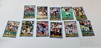 Fronts of eleven 1991 Pacific NFL football cards laid out on table