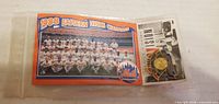 Front view of sealed pouch showing 1988 team photo card and pin