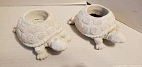 Two ceramic turtle candle holders top view