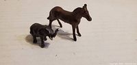 Front view of horse and elephant figurines upright