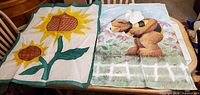 Both fabric flags laid out side by side on table