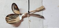 Top view showing both serving spoons, solid and slotted bowls