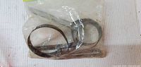 Two metal band oil filter wrenches inside clear plastic bag