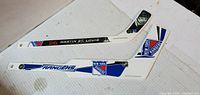 Two white plastic New York Rangers mini hockey sticks, full view