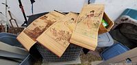 All three bamboo wall hangings draped over bin showing printed scenes and construction