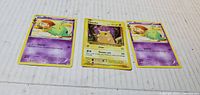 Front view of three Pokémon cards: Pikachu centered between two Gulpin cards
