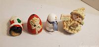 Front view of four egg-shaped Christmas figurines