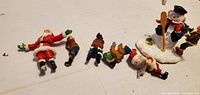 All six resin Christmas figurines laid out