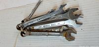 Stack of eight Sears combination wrenches tied together
