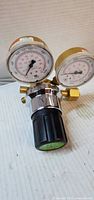 Front view showing two pressure gauges, brass body, control knob