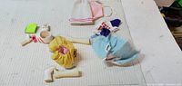 Overview of garments, plastic limbs, and small accessories on surface