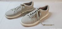 Pair of grey Calvin Klein sneakers, side view