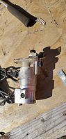Chrome corded electric tool with clear base and knobs on wooden surface