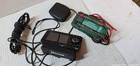 Overall view of Audiovox receiver, XM antenna and Commercial Electric multimeter with leads