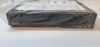 Front view of Sanyo DVD player in plastic wrap showing overall condition