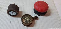 Front view of three tools: dial gauge, sanding drum, sander spool