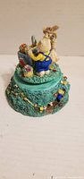 Figurine front showing rabbits and garden details
