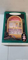 Front of green Hallmark Keepsake box displaying ballet scene and inset of ballerina ornament