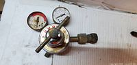 Top view of regulator showing Harris branding, cross handle and both gauge faces