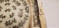 Close view of plate edge, holly design and box interior