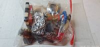 Bag of assorted painted wooden decorations, zebra pattern visible