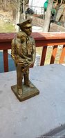Front view of bronze-tone policeman statue on table