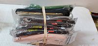 Bundle of packaged phone cases side view showing multiple colours