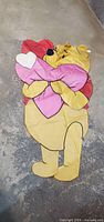 Full view of flag showing Pooh hugging hearts, vertical orientation