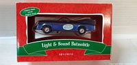 Front view of boxed blue Batmobile ornament showing Light & Sound Batmobile labeling