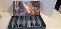 Closed box showing Longchamp branding and violin graphic