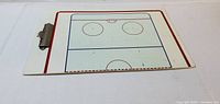 Front side showing half rink diagram and metal clip